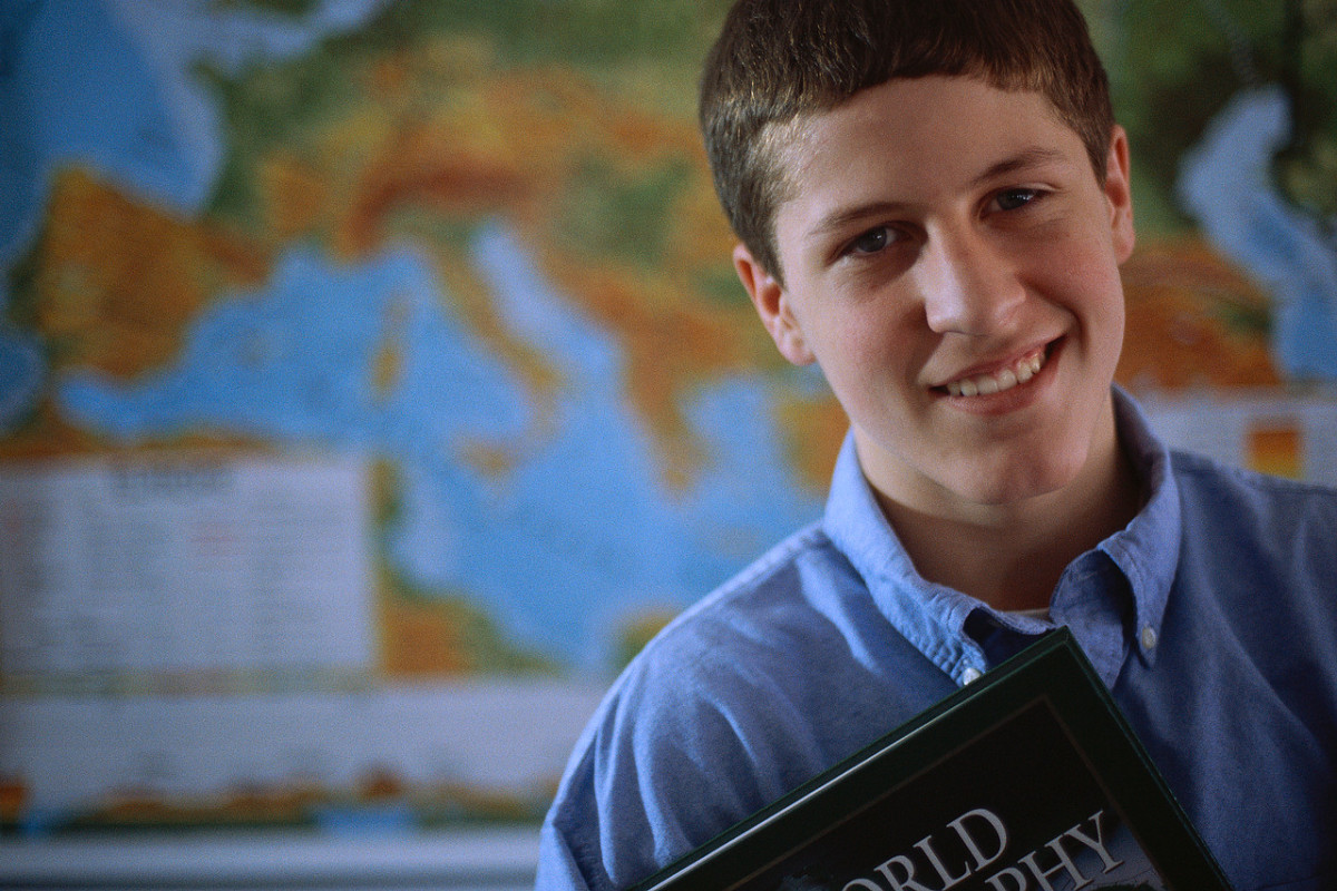 Adolescent Boy Holding a Textbook ca. 2000