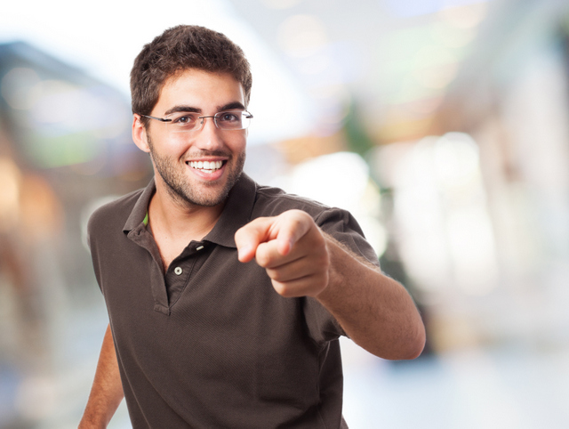 portrait of handsome young man pointing to the front